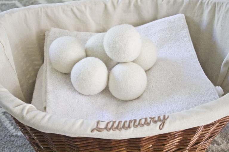 Natural Fabric Softener Alternatives with dryer balls on laundry basket
