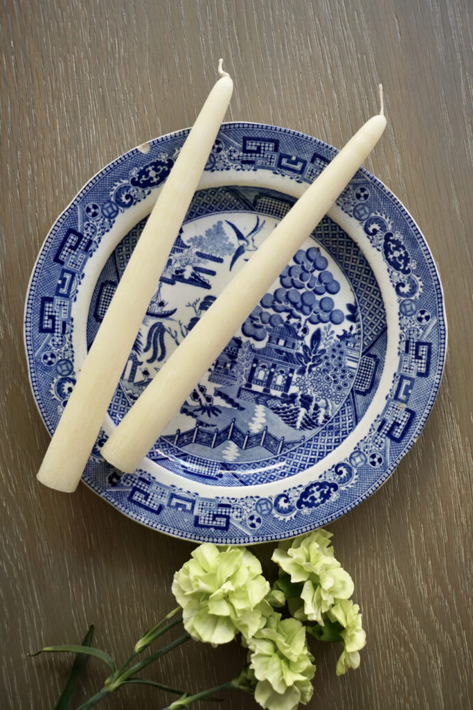 Cozy scene with a burning soy wax candle, showcasing longer burning time and cleaner burn.