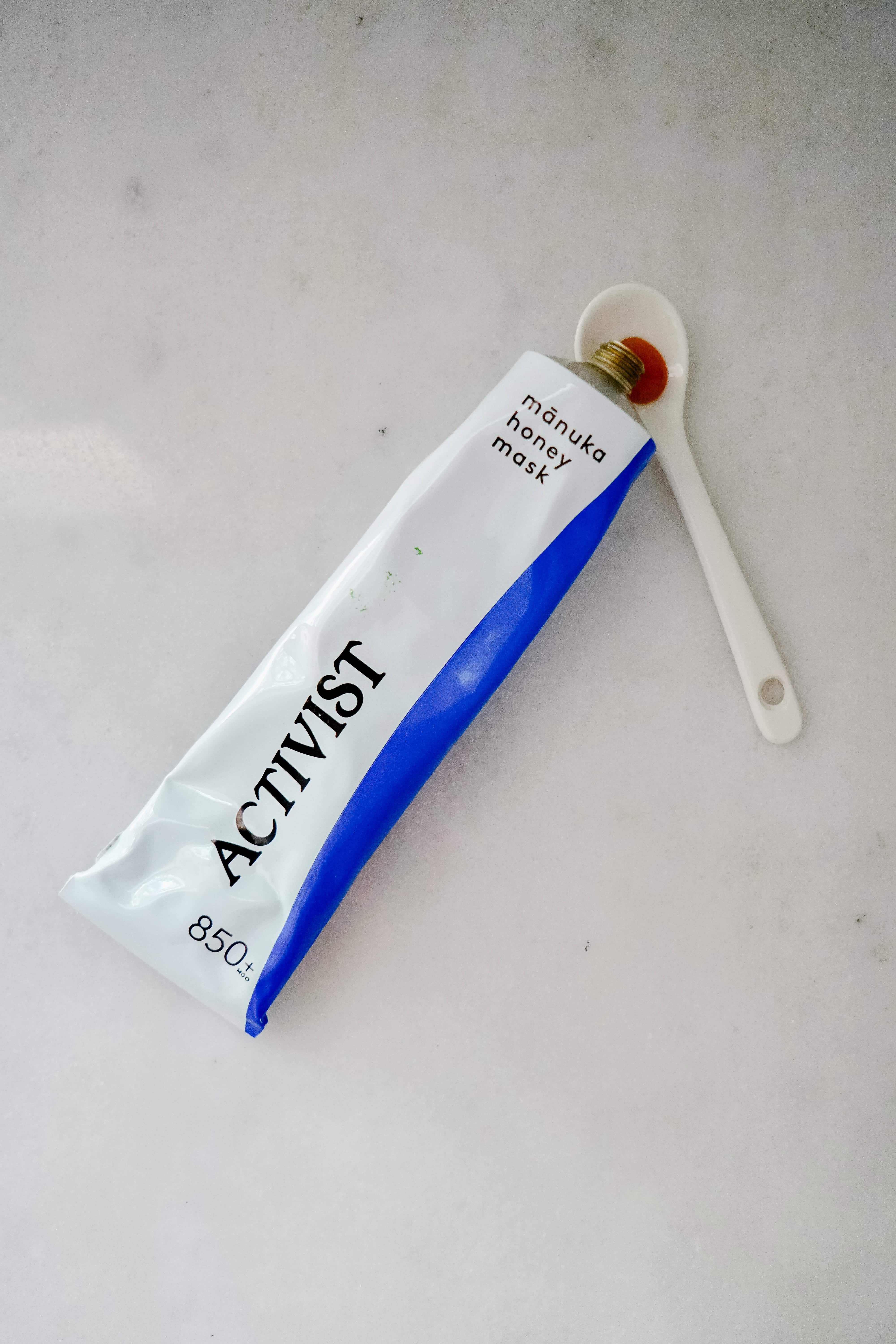 Open tube of Activist Manuka Honey mask showing rich, golden texture