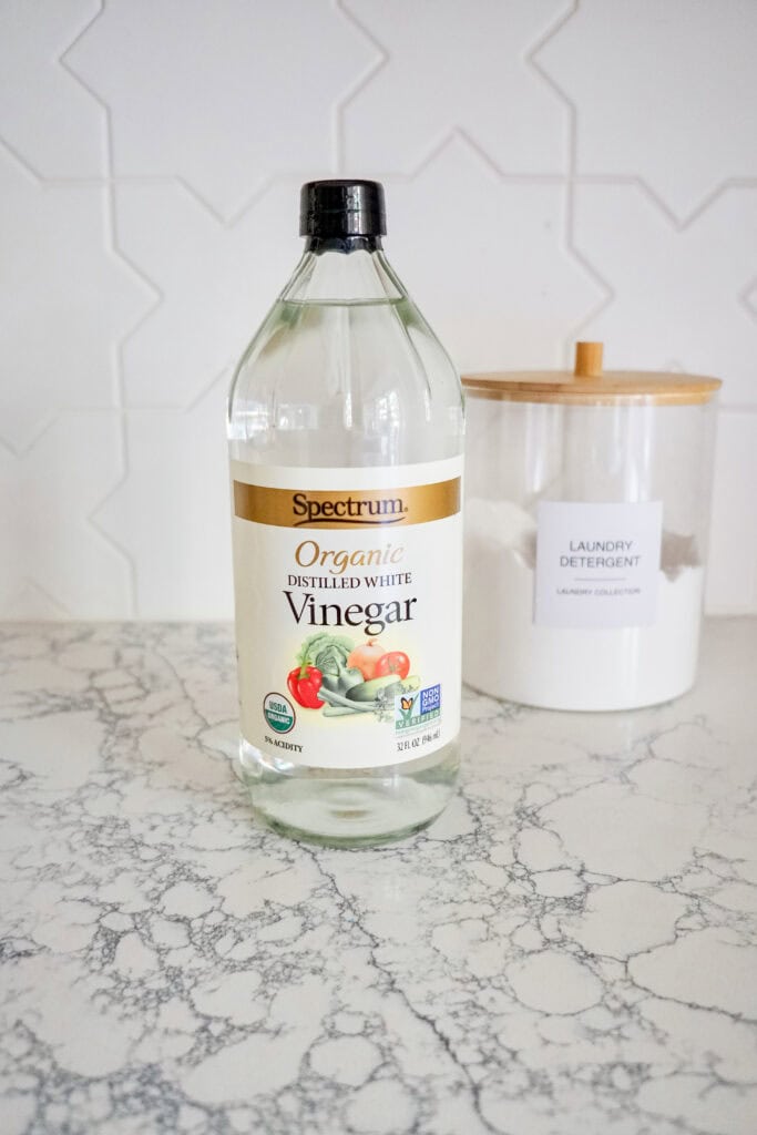 White vinegar next to laundry detergent, a Natural Alternative To Fabric Softener